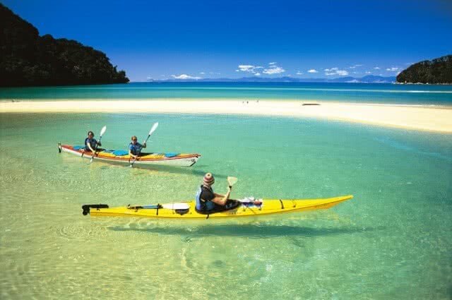 View of two kayakers enjoying the clear waters of the Abel Tasman National Park