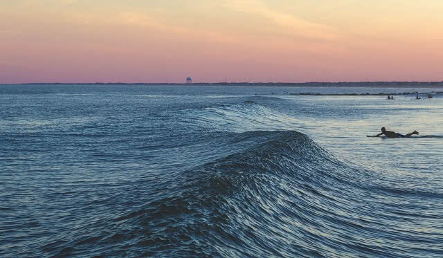 Surfing at sunset along Surf Highway 45 in Taranaki