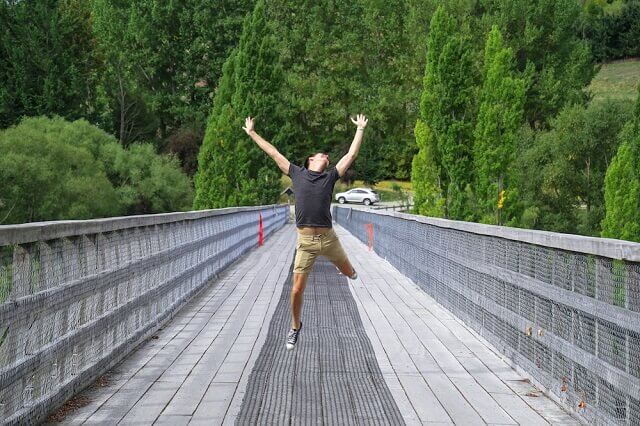 Guy jumping on a bridge in NZ