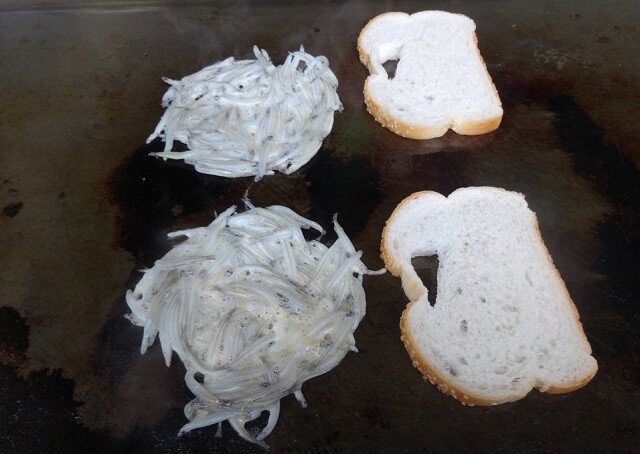 Whitebait fritters and bread getting cooked