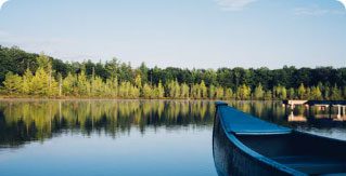 Image of the prow of a rowing boat on a lake