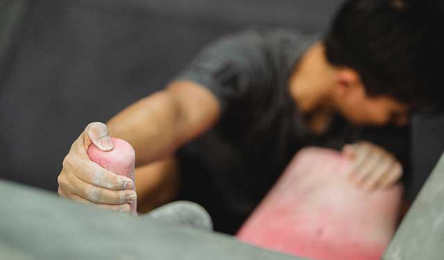 man climbing in indoor rock climbing gym