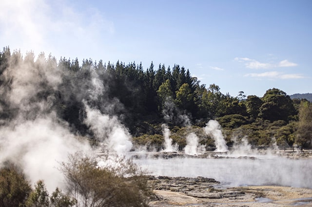 sulfur clouds coming from the volcanic pools