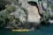 2 yellow kayaks in front of a large Maori carving that has been etched into the cliff face beside Lake Taupo