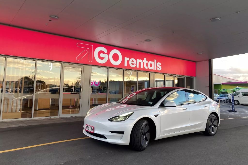 tesla vehicle in front of go rentals