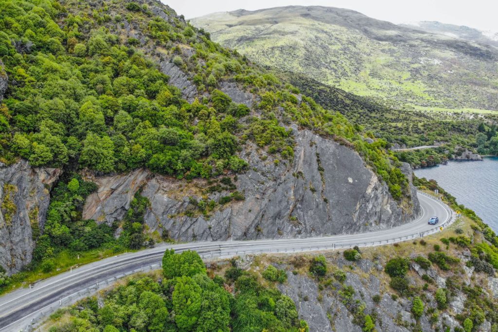 car driving on tight mountain road